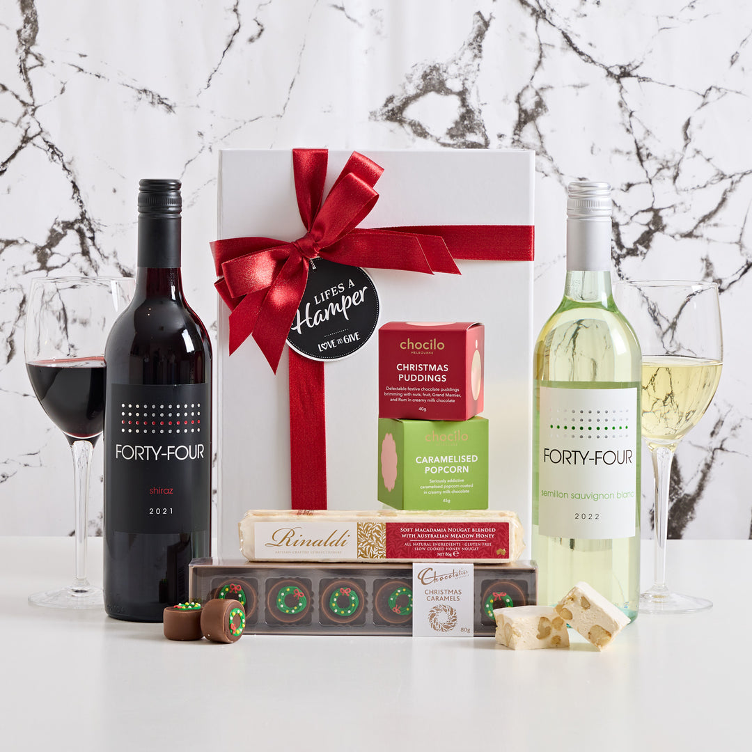 Red and White wine Christmas hamper comes with a selection of delicious sweet Christmas treats. Surprise & delight this festive season with this impressive Christmas hamper.