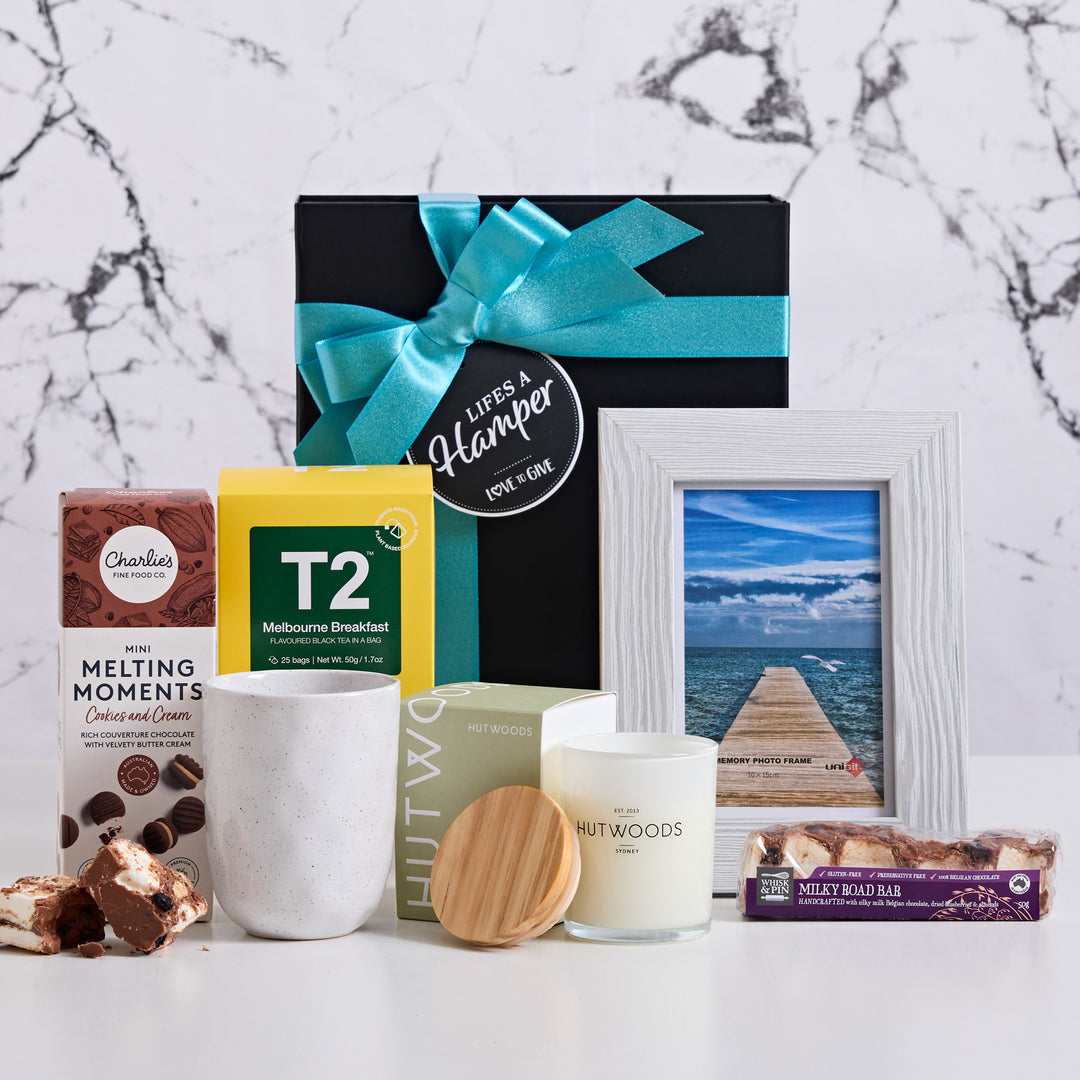 In loving memory is a hamper designed to send condolences in time of need. It includes an Ecology tea cup, T2 english breakfast tea, Hutwoods candle and some sweet treats.