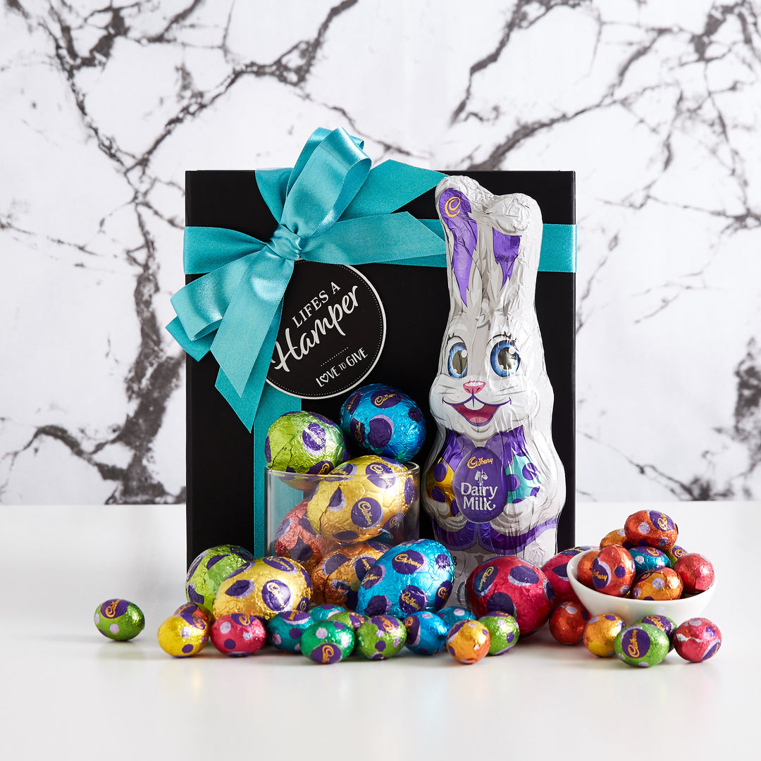 Cadbury Milk Chocolate Easter Egg Hamper includes a Cadbury Milk Chocolate easter bunny and milk chocolate easter eggs.