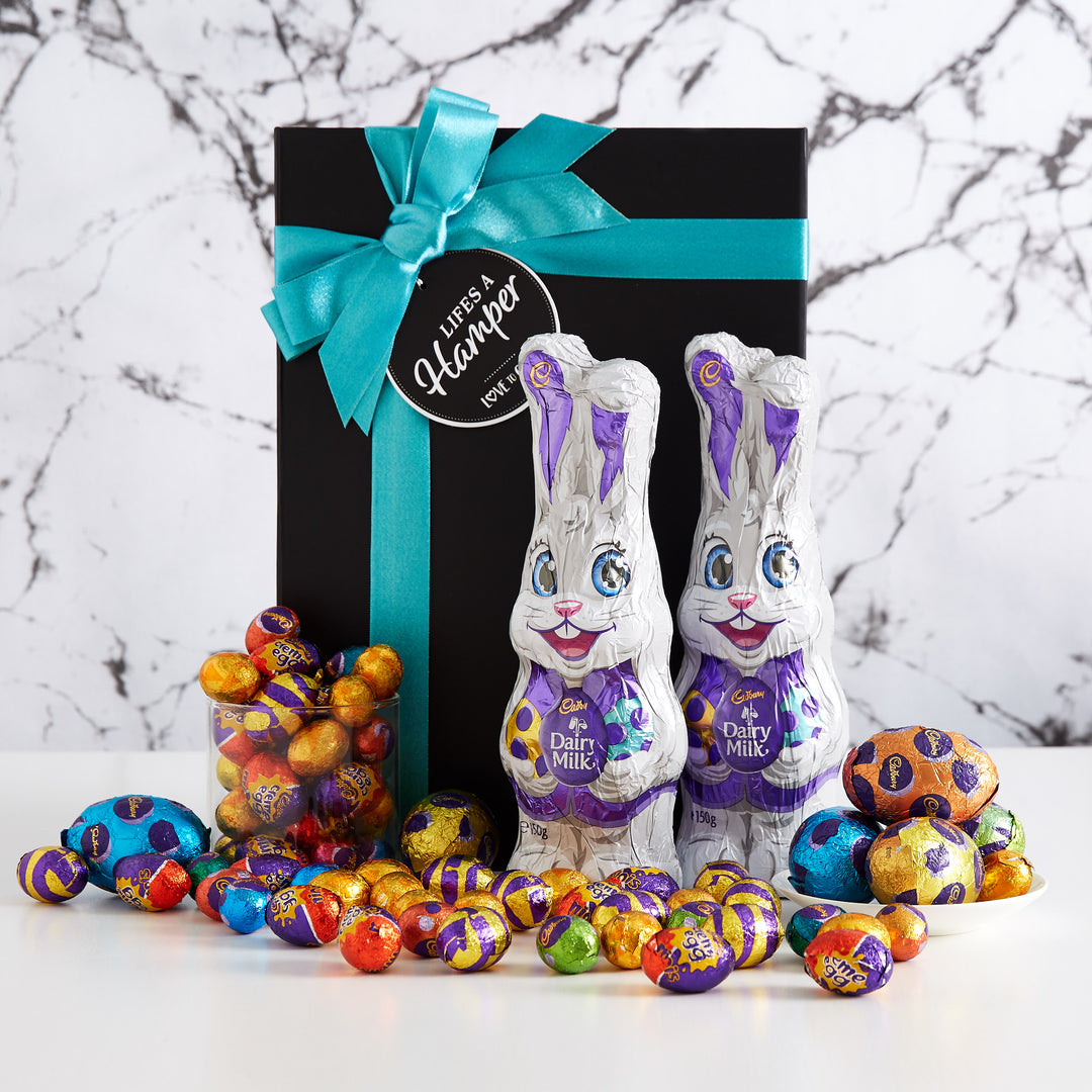 Cadbury Share Easter Hamper includes two cadbury milk chocolate bunnies, hollow eggs and a mixed assortment of small easter eggs. The perfect gift for an easter team celebration.