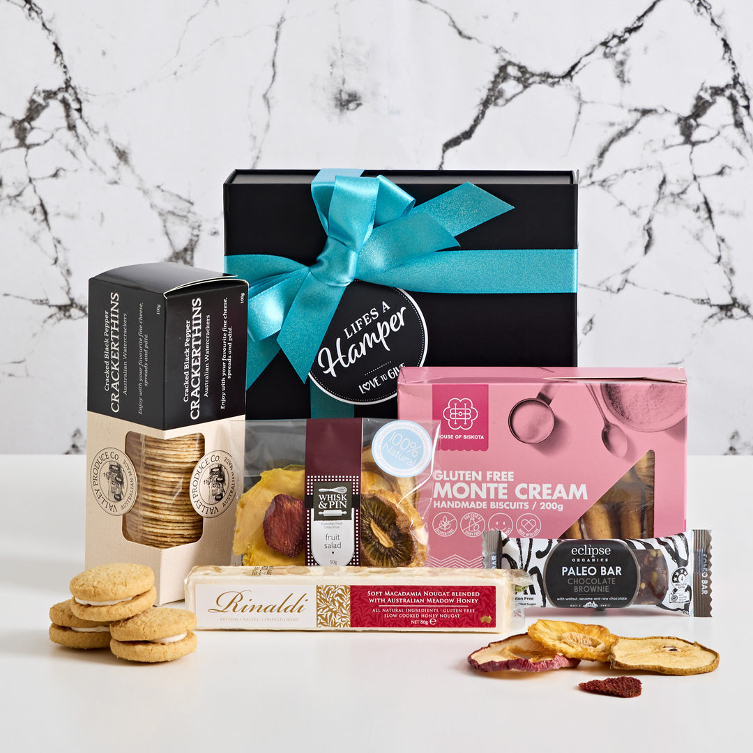 Dairy & Gluten Free Hamper is filled with sweet & savoury delights your recipient will love. This gift box includes Hoouse of Biscota Monte Cream, Whisk & Pin Fruit Salad, Crackerthins, Rinaldi Honey Macadamia Nougat and eclipse chocolate brownie paleo bar.
