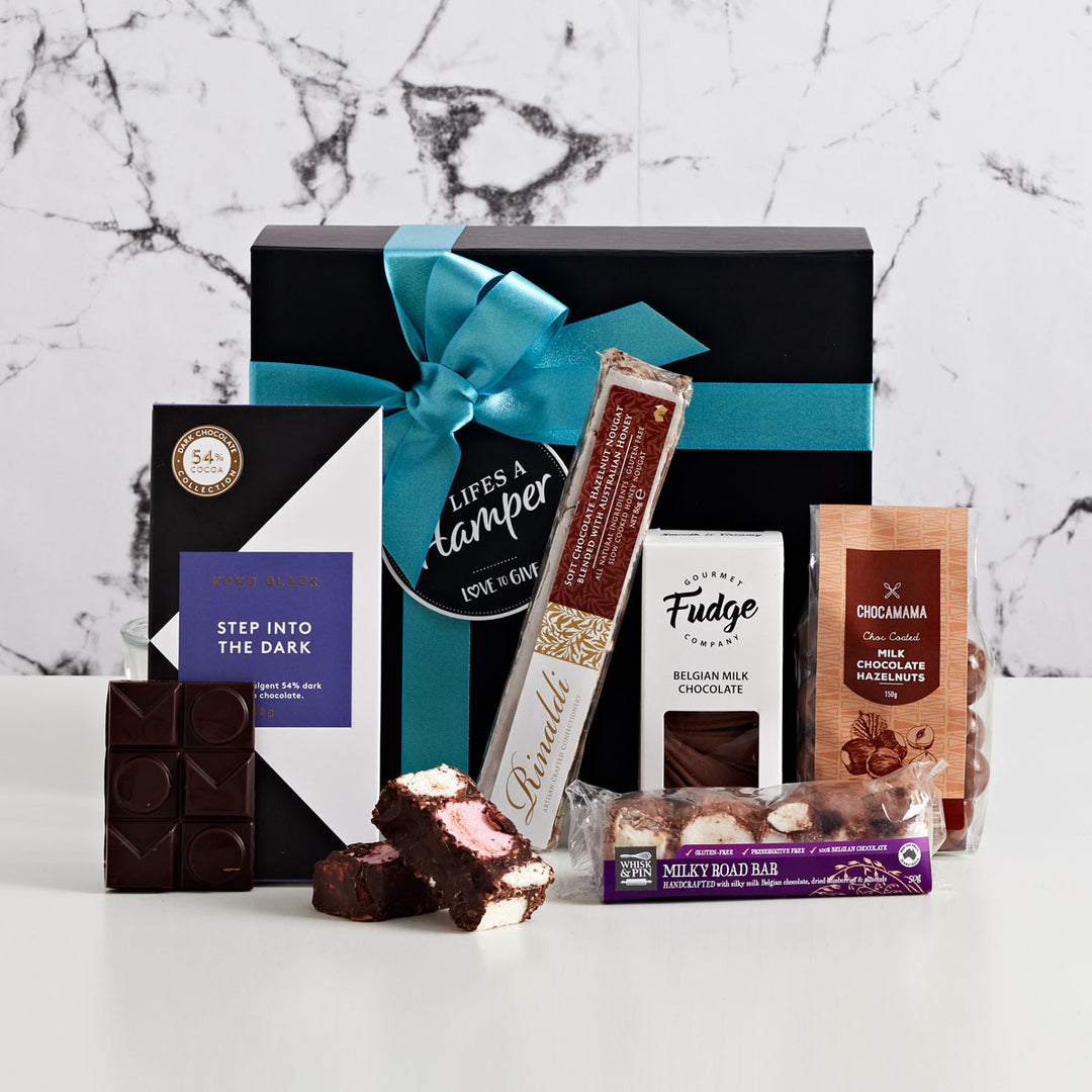 Chocolate Box Hamper is one of our most popular hampers. It comes with Koko Black Chocolate Bar, Chocolate Hazelnut, rocky rd and chocolate fudge. This Chocolate Box hamper is every chocolate lovers dream.