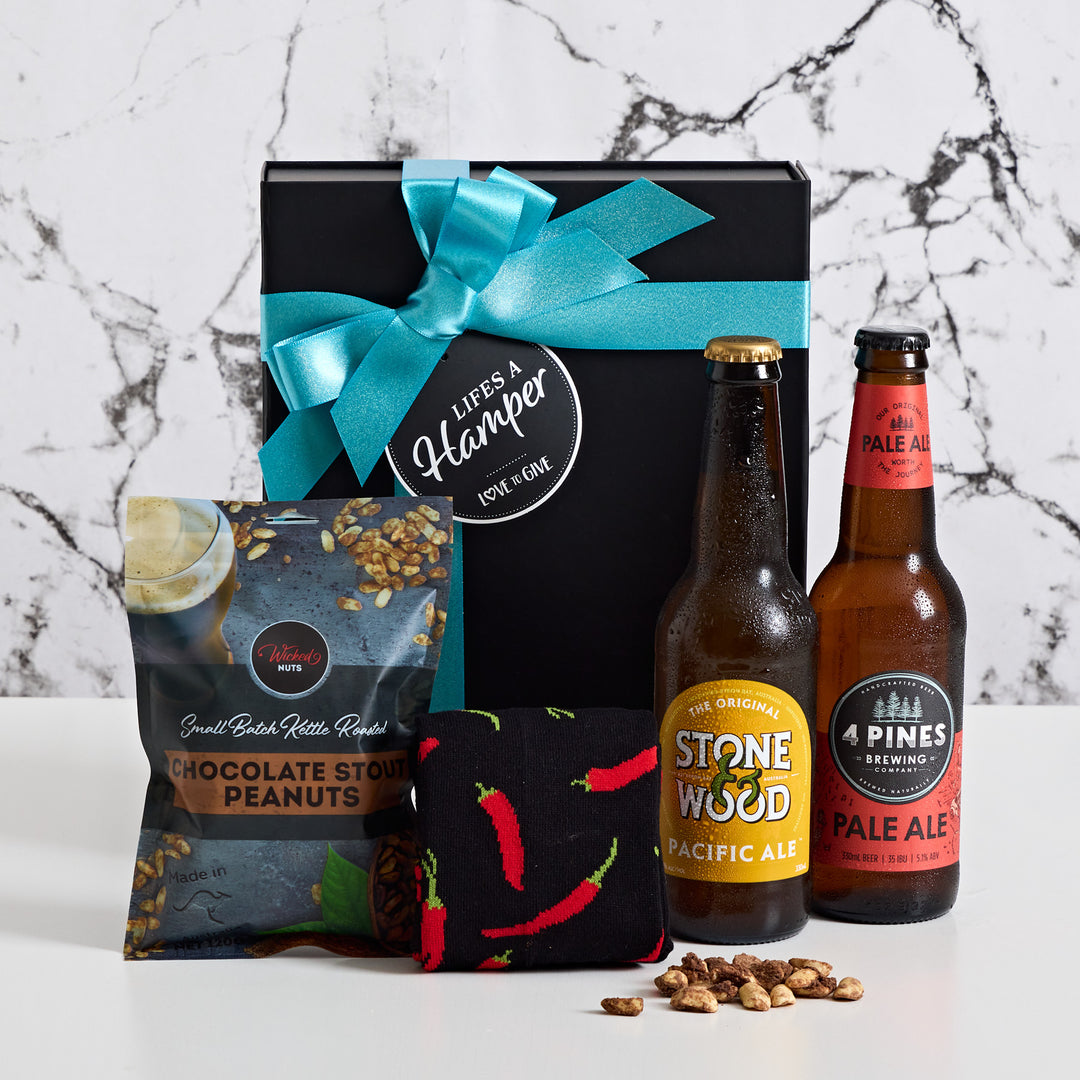Craft Beer Gift box is the perfect gift hamper for all males regardless of the occasion. It comes with a bottle of Stone and Wood Pacific Ale, 4 Pines Pale Ale along with wicked nuts chocolate stout peanuts & modern mens chilli socks