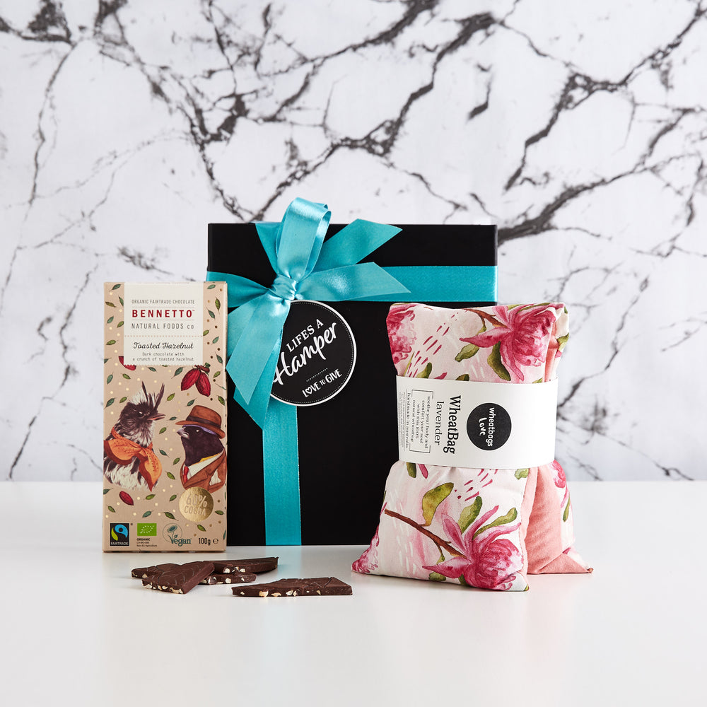 Time Out Gift Hamper comes with a black box with Turquoise ribbon. This gift hamper is a perfect gift to show someone your thinking of them. It comes with a lavender scented wheatbag and a block of bennetto chocolate.