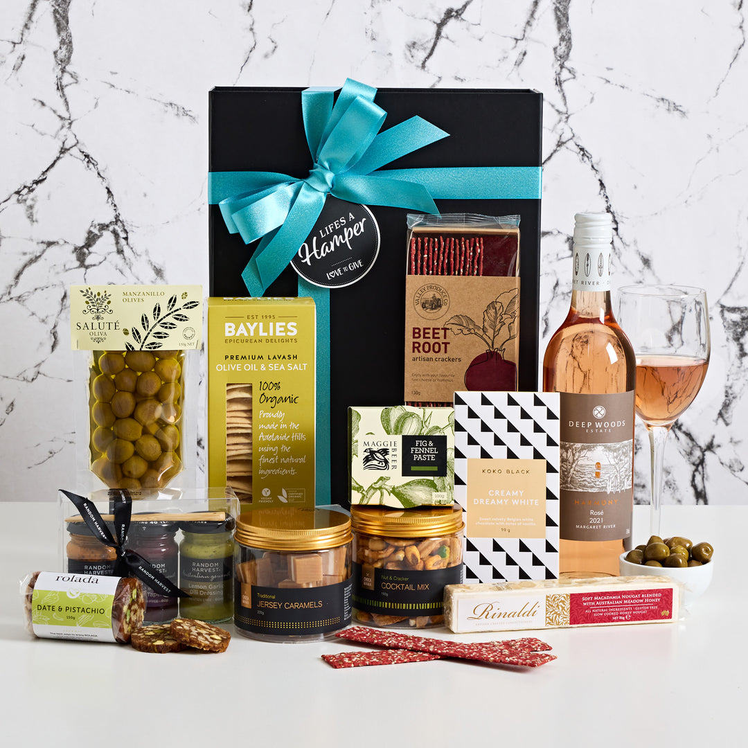 Treats with rose hamper comes with a selection of artisan treat your recipient will devour. It includes koko black chocolate, crackers,  random harvest mini me entertaining sampler pack along with a creamy honey macadamia nougat.