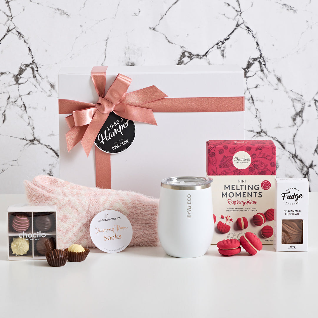 Warm wishes gift hamper includes evereco insulated tumbler, annabel trends lounge socks, raspberry bliss mini melting moments, Chocolate fudge and Chocilo Chocolate truffles. Make someones day special with our warm wishes gift hamper.